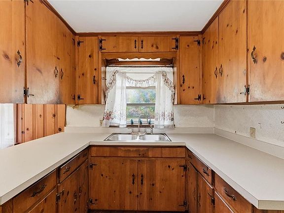 Kitchen featuring wood finish cabinetry, a peninsula, and light countertops