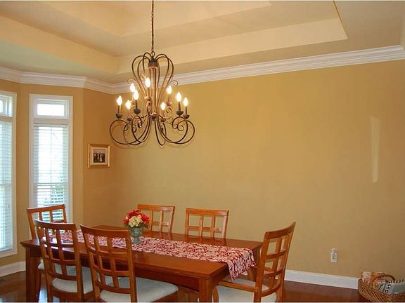 "A double tray ceiling and elegant fixture crown the room"