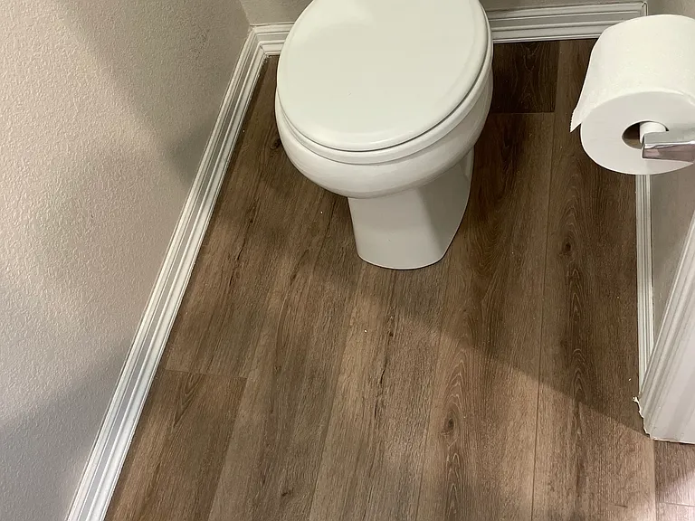 Second floor master bath, showing new LVP flooring.
