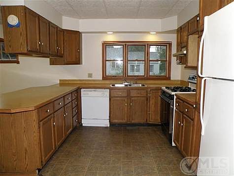 Photo:  Kitchen has newer vinyl flooring.  Appliances included as shown. Lazy susan pantry next to fridge.