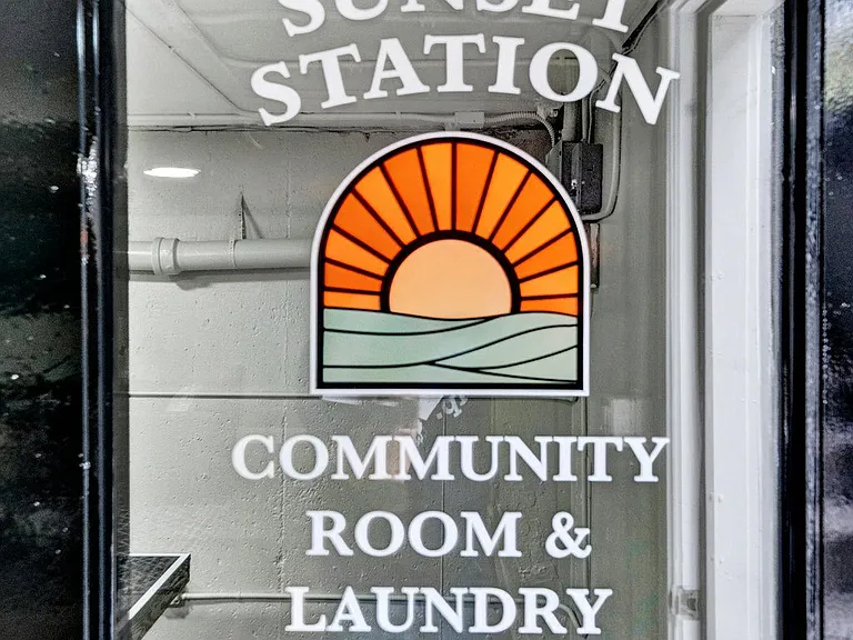 a sign on the door of the sunset station community room and laundry center Sunset Station Apartments Portland Oregon
