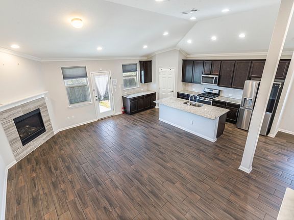 Kitchen open to family room with fireplace