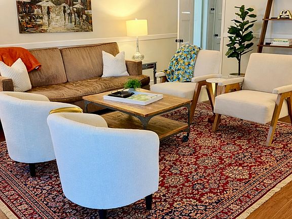 The den area has plenty of seating and space to relax and entertain. This room is open to the kitchen, and has sliding doors open to the back patio