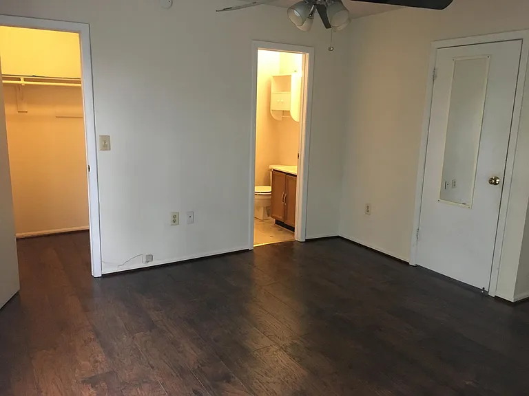 Master bedroom with master bathroom and walk-in closet
