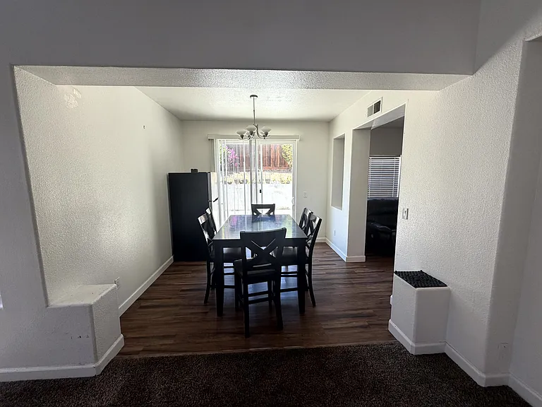 Dining area with backyard access through sliding glass doors.