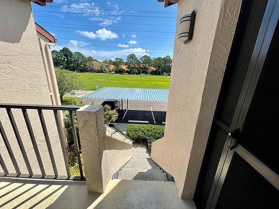 Stair access to 2nd floor home, view from outside front screen patio door.