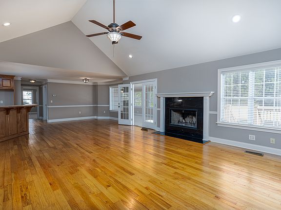 View from area leading to the two alternate bedrooms looking into living room, dining and kitchen