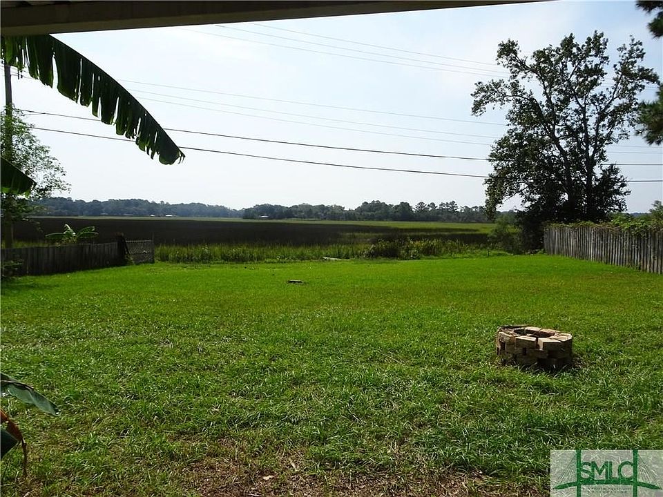 Large back yard with fire pit and extensive marsh views