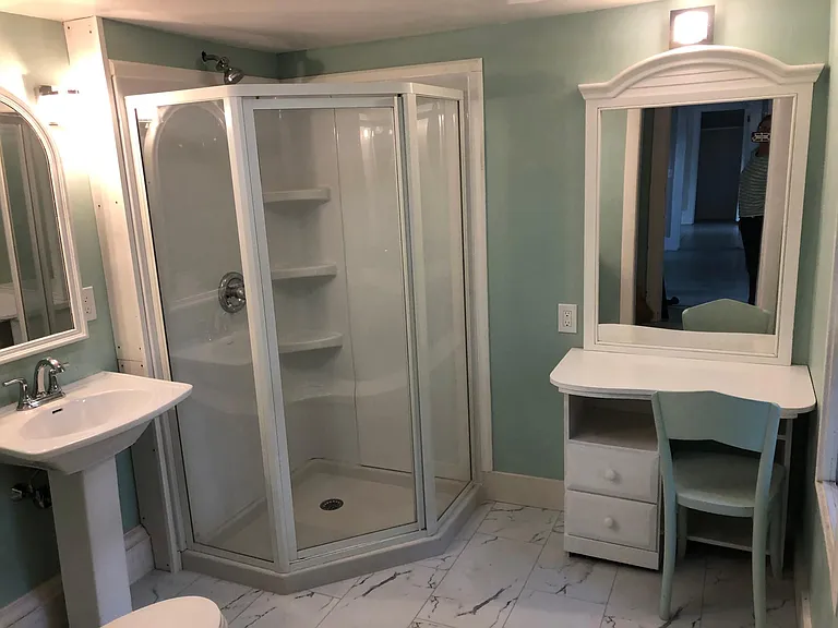 Upstairs bathroom off kitchen. Includes seated vanity with mirror.