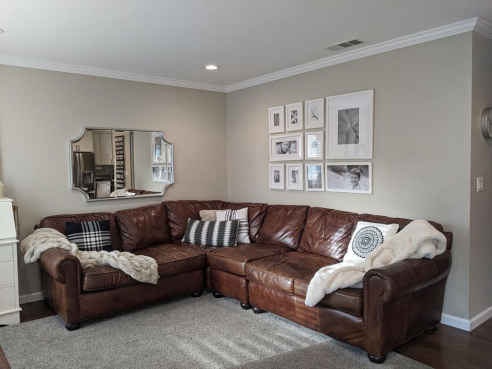 Family room with recessed lighting, crown molding and hardwood floors.