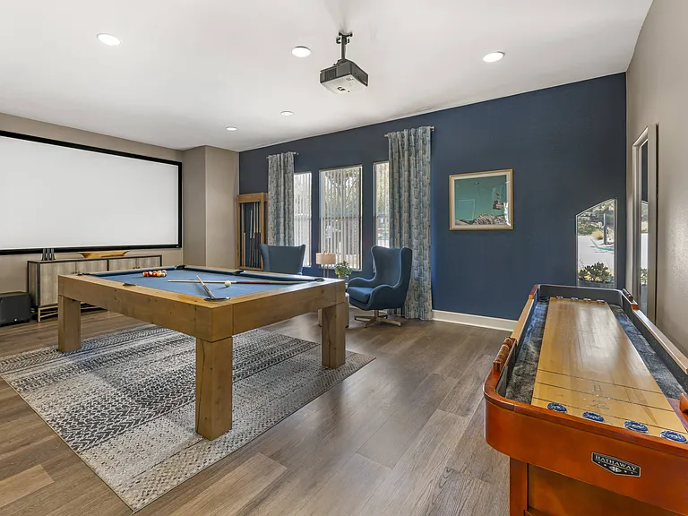 The rec room in the clubhouse is perfect for hanging out, featuring a pool table, TV, and shuffleboard for fun and relaxation at Ascent at the Galleria.