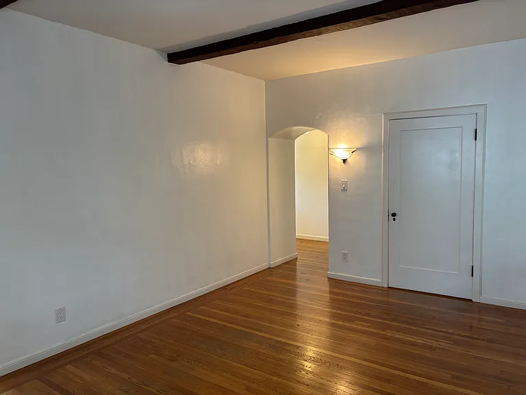Living room with real hardwood floors and beamed ceilings