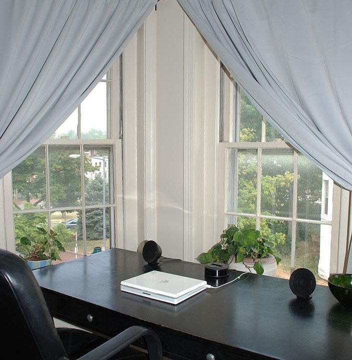 Bedroom windows look out onto E Street, with a view of the W