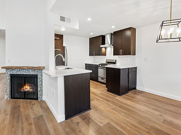 smart kitchen complete with vertical tray storage/ lots of drawer space/ and a fridge with Brita water filling inside.