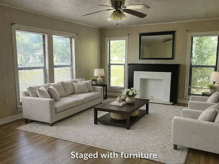Large living room with mock fireplace and lots of windows