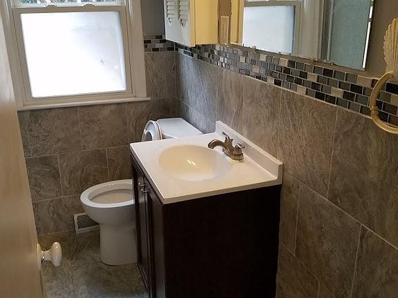 shower stall is opposite the vanity, to the left_