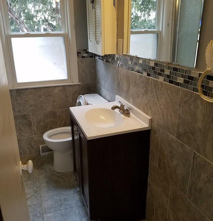 shower stall is opposite the vanity, to the left_