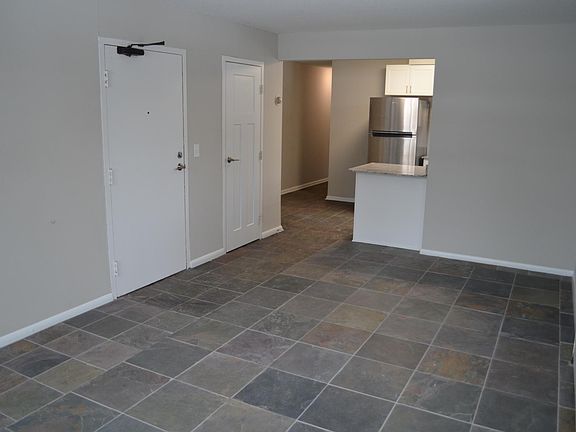 Living room looking into kitchen and dining nook. Walk-in entry closet.