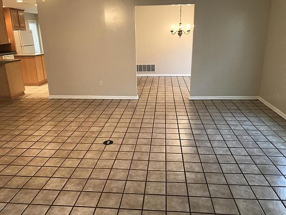 LIVING ROOM LOOKING INTO KITCHEN AND DINING