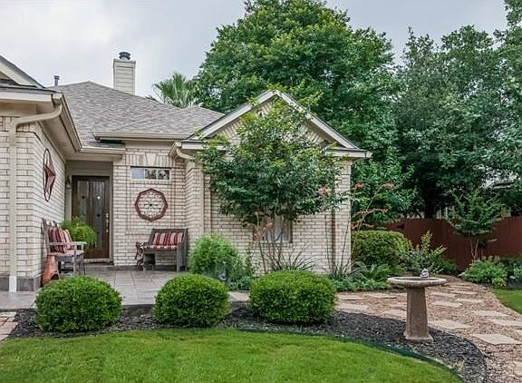 Sit back and enjoy your quiet Shangri-La at the seating area near the front door. The professional landscaping is at once attractive and designed with easy maintenance in mind.