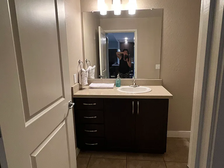 Second bathroom with one sink, toilet, and shower (no tub)