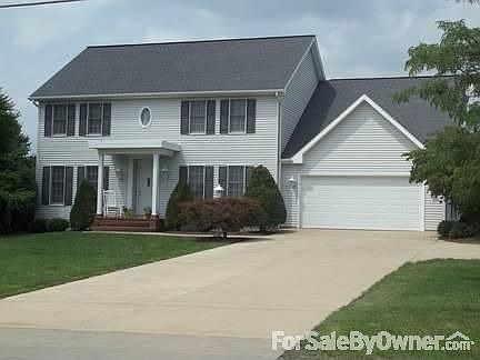View From Street
						:
						Concrete Driveway and Masonry Porch
