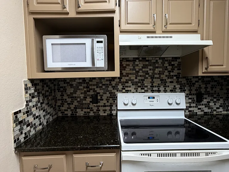 Equipped with a microwave, oven, and stove, ready to cook!