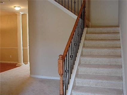 Entry Foyer: stairs have wrought iron spindles