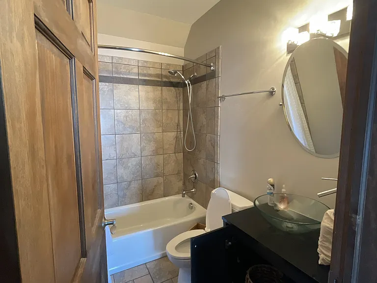 Bathroom with designer sink, toilet, and shower.