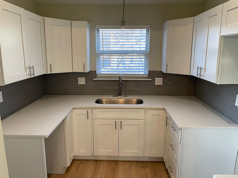 Kitchen with quartz countertops, soft-close cabinets, tile backsplash and stainless steel appliances coming soon!