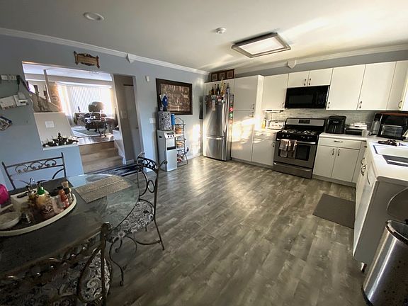 Kitchen shown furnished by previous tenant. Only the glass table and wrought iron chairs remain.