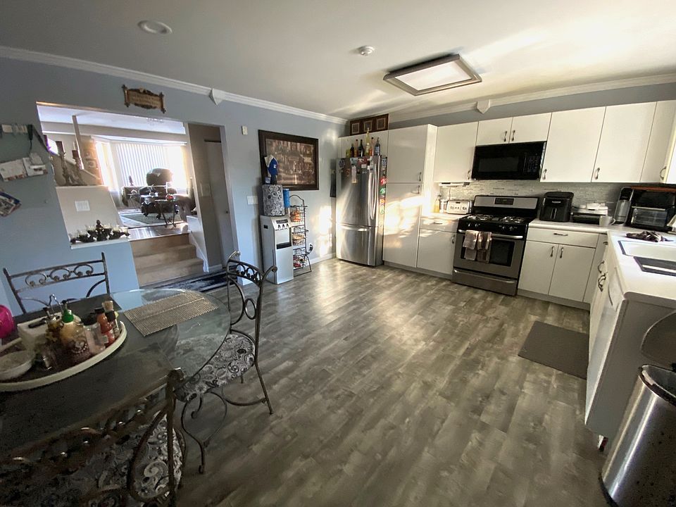 Kitchen shown furnished by previous tenant. Only the glass table and wrought iron chairs remain.