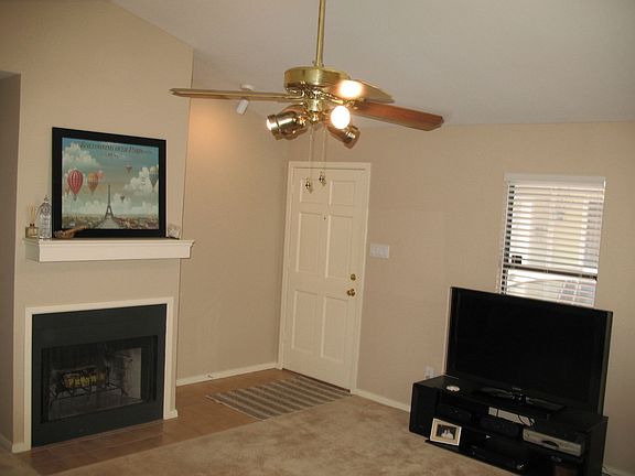 Living room, from corner, looking at entry way and fireplace