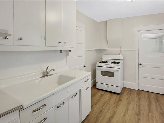 Kitchen with gas stove. Original doors and hardware.