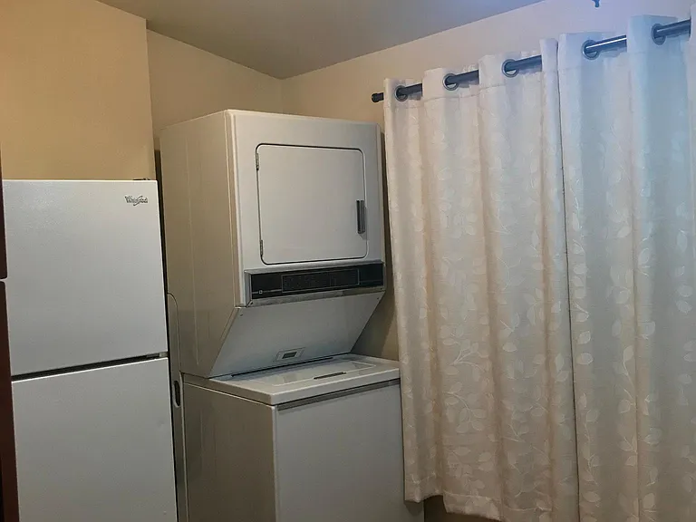 inside breakfast/utility room showing refrigerator and washer/dryer