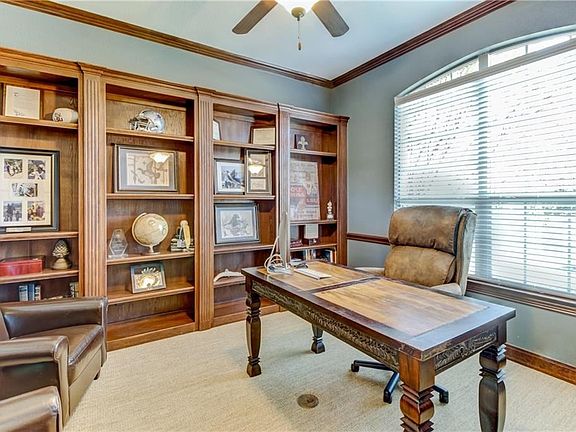 Office in front of home offers a wall of builtins, and French Doors for privacy.