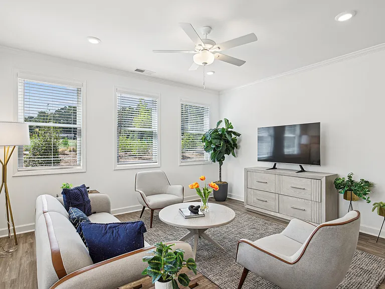 Sunlit living room with expansive windows.
