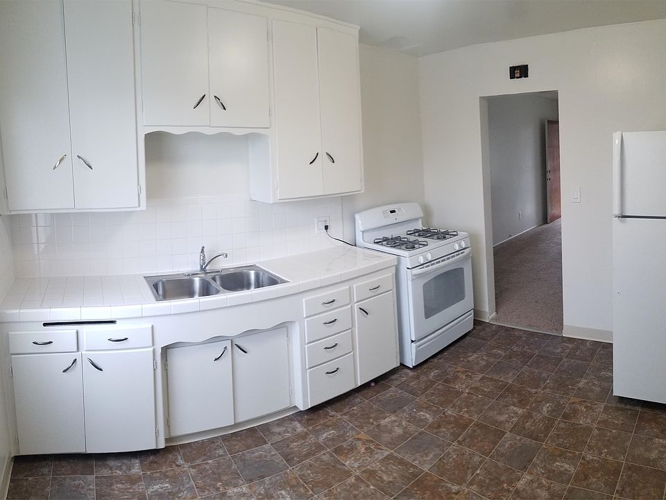 Kitchen. White tile countertop with white appliances.