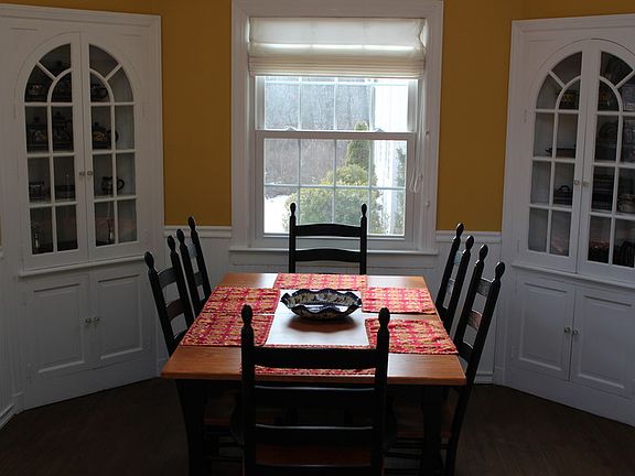 Attached Dining Room : Built-in corner glass hutches.
