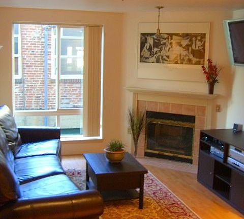 Spacious living room with wood floors throughout