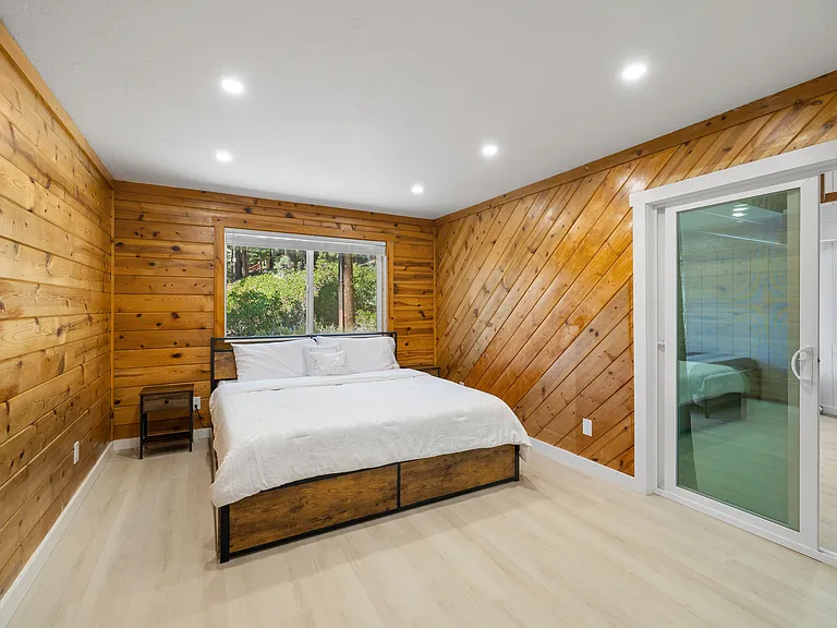 Downstairs Queen. Sliding glass door has curtain for privacy if desired.