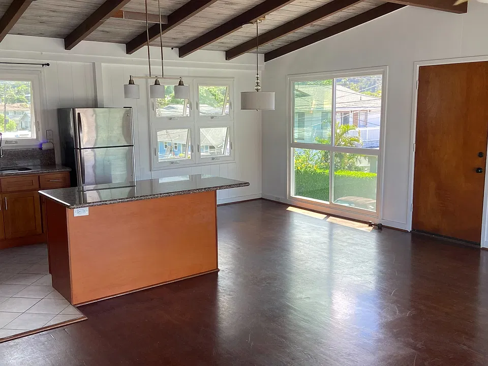 Kitchen:
Open kitchen with granite countertops, wood cabinetry, and stainless-steel appliances.