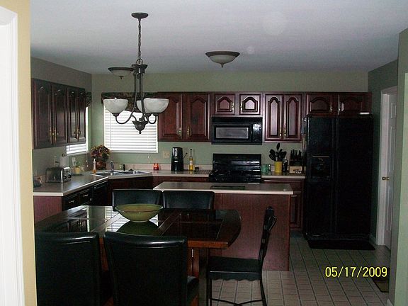 Cherry cabinets, corner sink, double windows