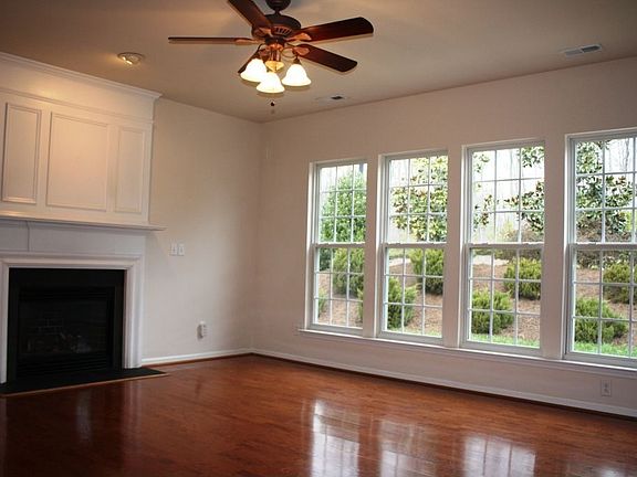 Plenty of natural light pours into the large family room with hardwood floors