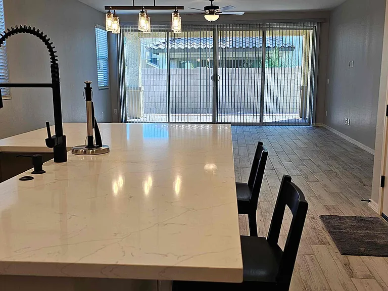 Open kitchen and living space with window shades