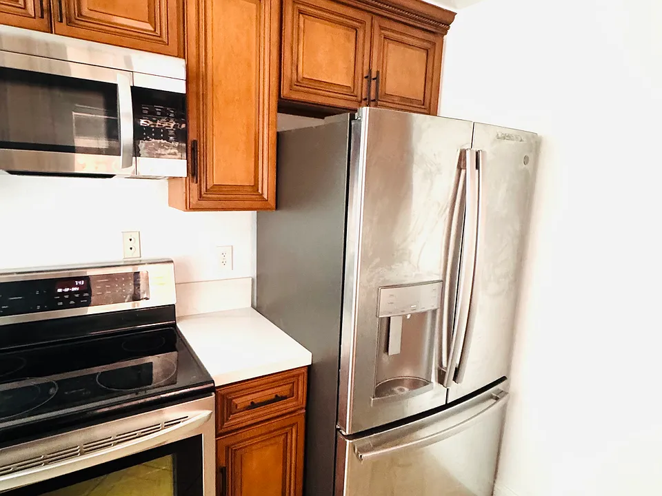 LG stainless steel microwave and stove set paired with a GE French door refrigerator.