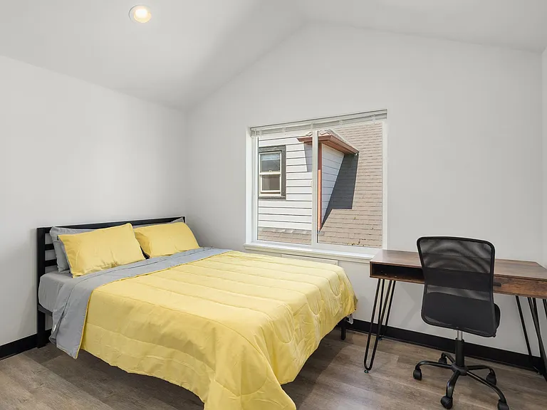Furnished bedroom with vaulted ceilings