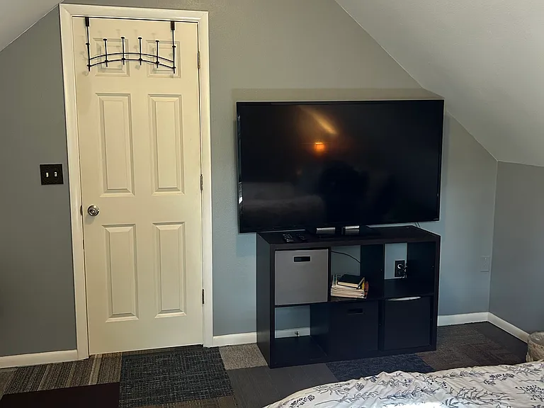 bedroom: queen bed, a/c in June-August months, 65" firestick TV, clothing rack, full length mirror, extra pillows and blankets, heat, portable fans