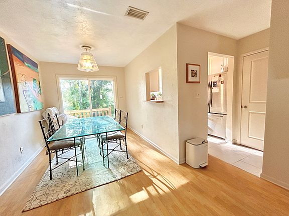 Dining Area And Kitchen With a View of The Back Yard And Deck