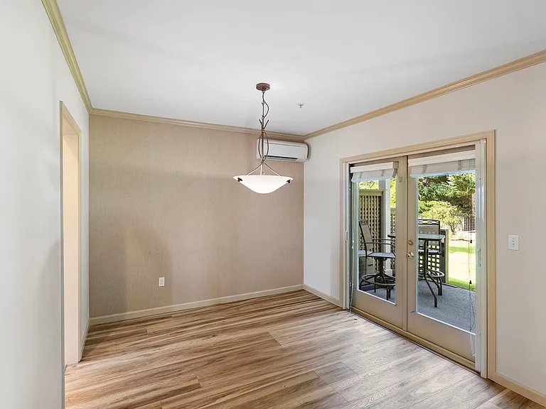 French doors leading from dining area to private back patio and shared backyard.